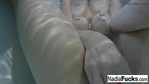 Sexy Nadia bathes with rubber duckies in solo relaxation