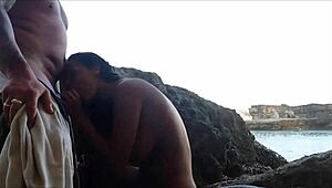 couple getting steamy making love right by the sea.