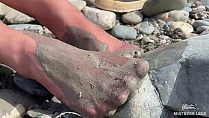 Goddess flaunts filthy nylon feet in torn pantyhose by river