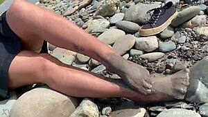 Goddess flaunts filthy nylon feet in torn pantyhose by river