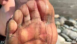 Goddess flaunts filthy nylon feet in torn pantyhose by river