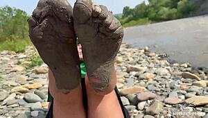 Goddess flaunts filthy nylon feet in torn pantyhose by river