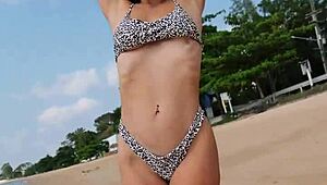 Petite girl waits on summer beach