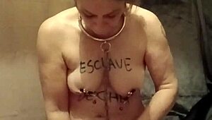 Female slave self-bonds for homemade spanking session.