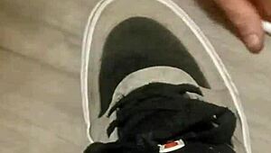 Why is my friend having so much fun trashing my sneakers? Provocative foot fetish scene.