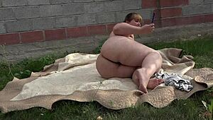 BBW enjoys anal play in the garden with a toy 😏