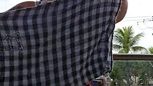 Exhibitionist flashing ass under skirt on balcony