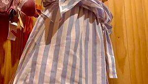 Latina teen tries on clothes in shopping center fitting room