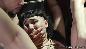 Pawg individual experiences double interaction while restrained. This occurs in a group setting with varied participants.