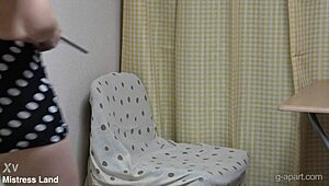 Mini Skirt Japanese Girl Sits on Chair in Apartment, Reading Porn Books While Fingering Her Cute Pussy Under Desk