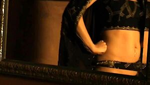 an exotic brunette lover from india dances seductively, teasing with her erotic striptease and undressing in a softcore display.