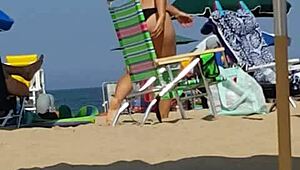 Hey, check this candid bikini slut at the beach 😏