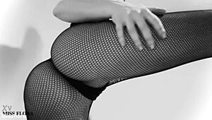 this brunette babe teases in fishnet tights, showing off her ass and feet. she poses in black and white for an interracial fetish vibe.