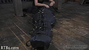 Restrained girl faces punishment in garage setting