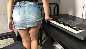 this curvy young woman slips into a tight skirt for some engaging keyboard lessons that highlight her natural charm and exhibitionist flair