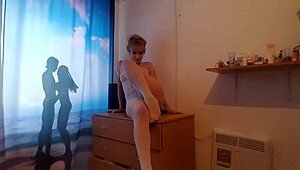 The blonde milf known as White Queen pleasures herself on the table in a captivating display.