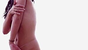 skinny canadian brunette kristie taylor teases in bikini on beach rocks with legs spread wide