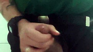 In the mall bathroom, the security guard casually takes a break to masturbate solo.