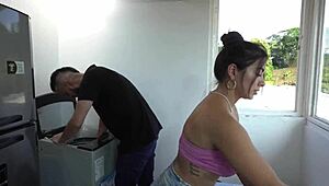 the latina lady entertains the repairman in the kitchen while waiting for her husband