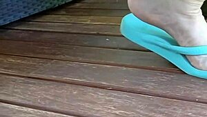 Mature squats spreads legs wide outdoors