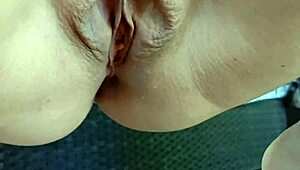 Mature squats spreads legs wide outdoors