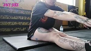 sexy tattooed alternative stretches teasingly in gym