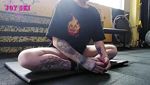 sexy tattooed alternative stretches teasingly in gym
