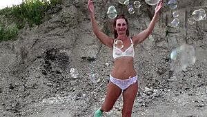 Mature Crossdresser Covers Transparent Bikini in Soap Bubbles