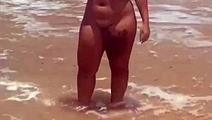 young african exhibitionist strips fully nude on crowded beach