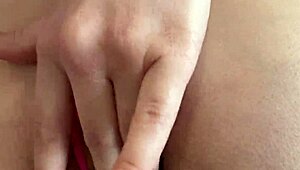 Pretty girl spreads hairy pussy close-up through thong panties