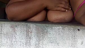 Crente safada flashing her huge natural tits out the window for all the street guys to devour