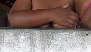 Crente safada flashing her huge natural tits out the window for all the street guys to devour