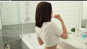 brunette steps under the warm shower, fingers her shaved wet pussy till she cums