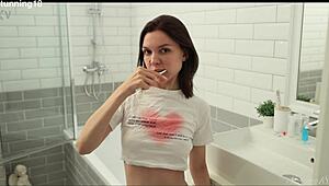 brunette steps under the warm shower, fingers her shaved wet pussy till she cums