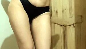 the colombian beauty sways her hips in a slow sensual dance under dim lights