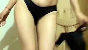 the colombian beauty sways her hips in a slow sensual dance under dim lights