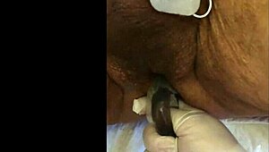 guy tries fisting with electrodi gadget close up