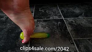 barefoot femdom tramples with banana toy underfoot