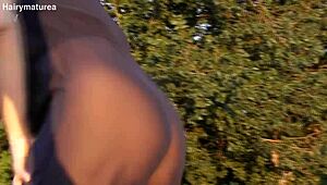 hairy chubby mature flashes her beaver through see-through fabric outdoors