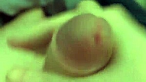 Stroking huge cock while eyeing amateur porn clips