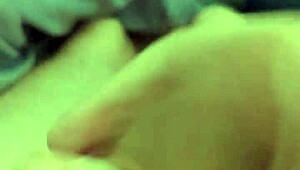 Stroking huge cock while eyeing amateur porn clips