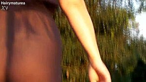 hairy chubby mature flashes her beaver through see-through fabric outdoors