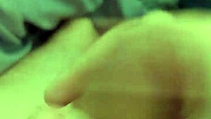 Stroking huge cock while eyeing amateur porn clips