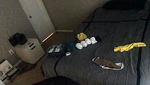 Bald girl folds laundry nude ignoring voyeur on webcam