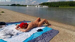 Ariela the Hungarian housewife flashes her shaved pussy outdoors. She rides cock publicly on the Danube bank naked and wild