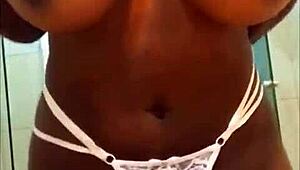 An ebony woman reveals her voluptuous figure and ample bosom in a captivating tale of allure and curves