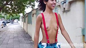 skinny latina flashes her small tits and hairy pussy under suspenders microskirt while topless on the street