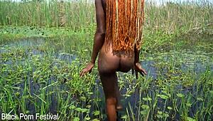 hey slim african babe with soft butt washes up in the river outdoors