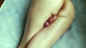 shiny oiled shemale crossdresser shakes big butt in homemade solo spanking session