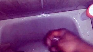 guy strokes his big black monster cock while showering and bathing until cum explodes